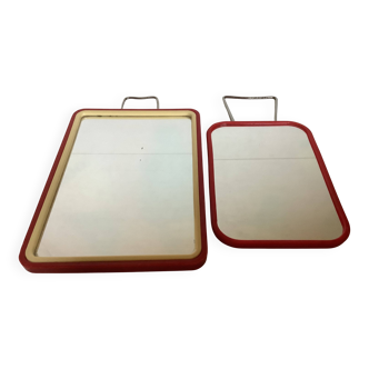 Pair of small red barber-style mirrors.