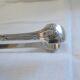 Christofle Silver-plated metal sugar tongs with crossed ribbon bow design