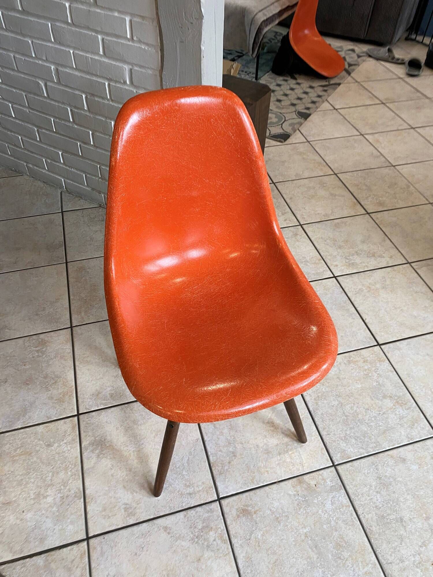 A vintage 70s Eames Herman Miller DSW Fiber Red Orange Dowel Walnut Chair
