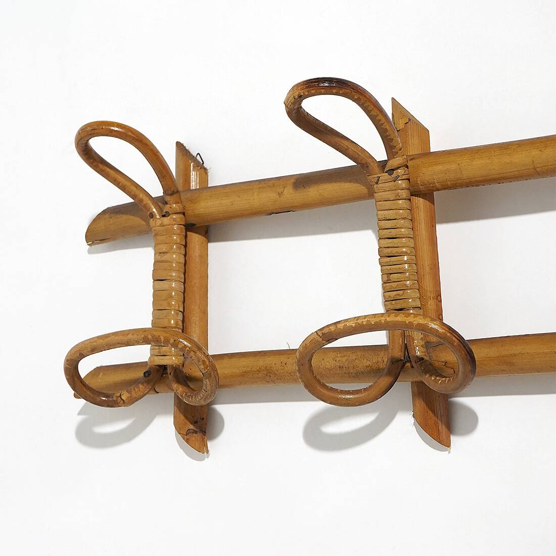 Wall coat rack in rattan and woven wicker, 1960s.
