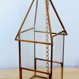 Greenhouse in the shape of a small house