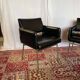 Pair of vintage armchairs in black faux leather and chrome metal.