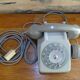 Grey vintage rotary dial phone with earpiece