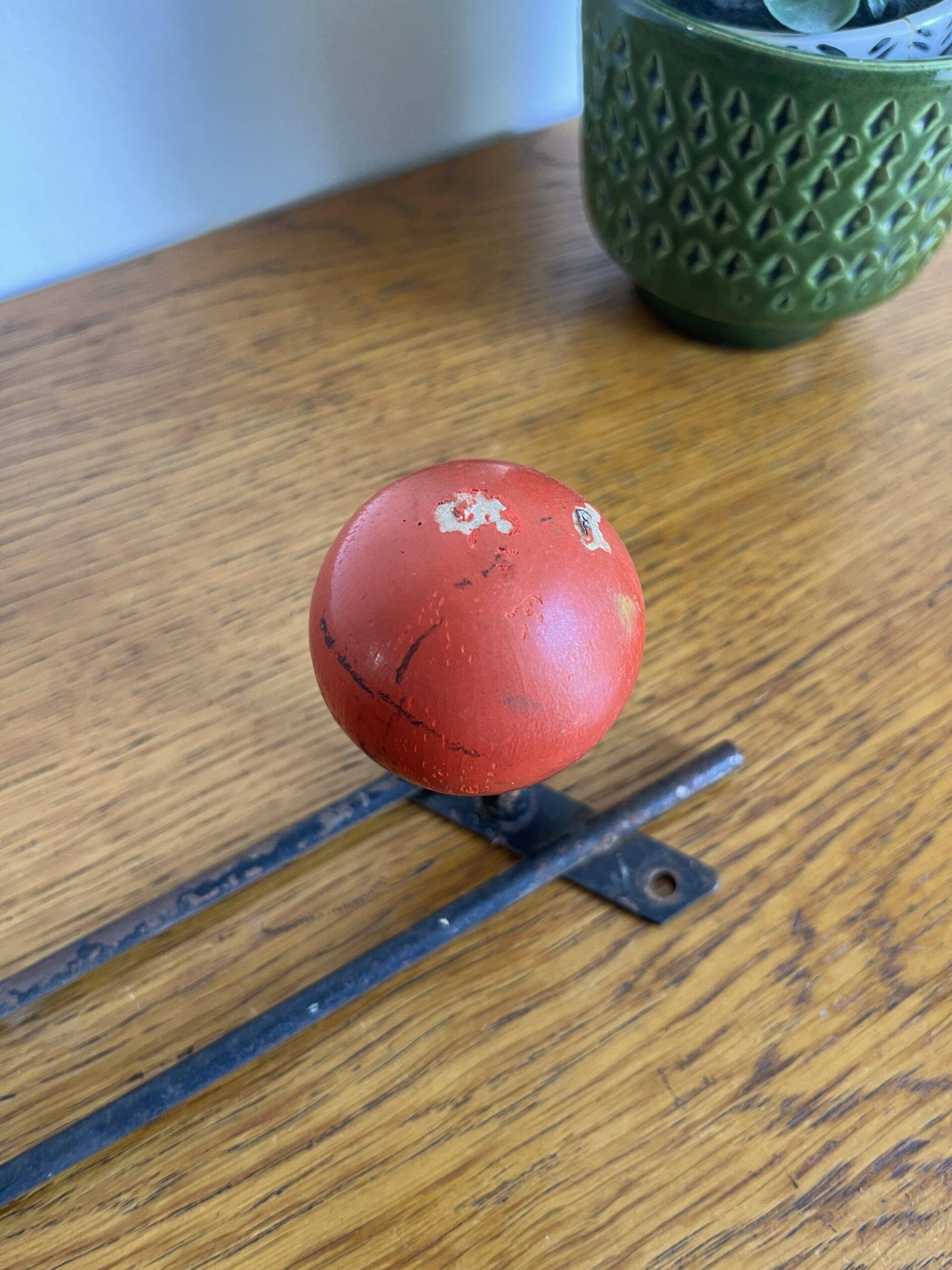 Coat rack with 3 red wooden balls