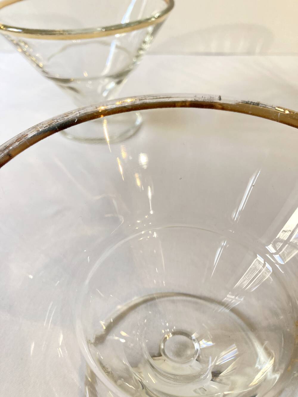 Trio of glass dessert bowls with gold rims, La Rochère, France