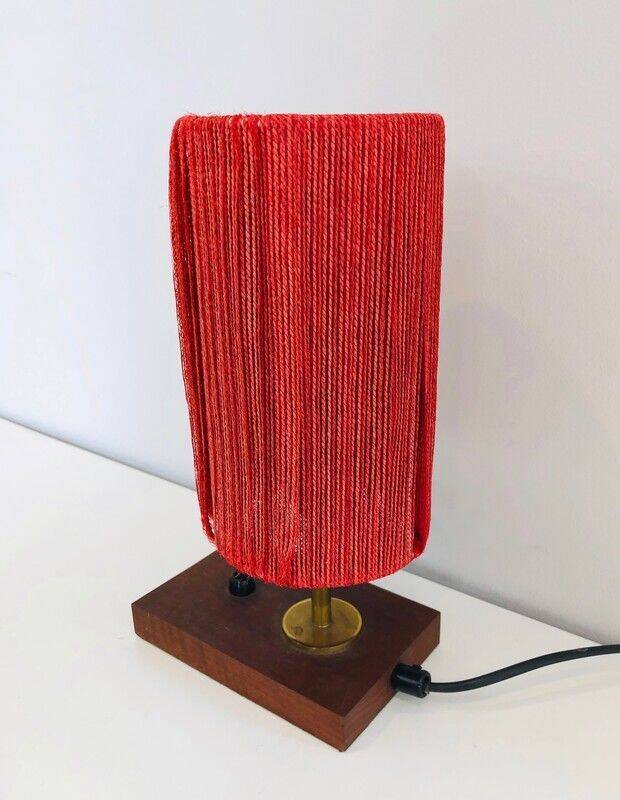Small lamp made of wood, brass, and wool.