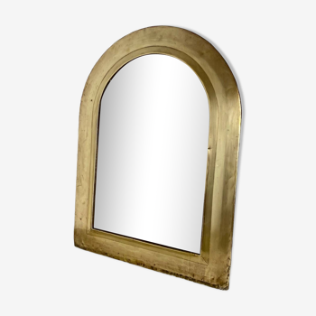 Large half-moon mirror in brass