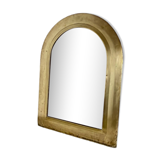 Large half-moon mirror in brass