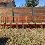 Set of 8 teak lounge chairs with high backs and zebra-striped seats