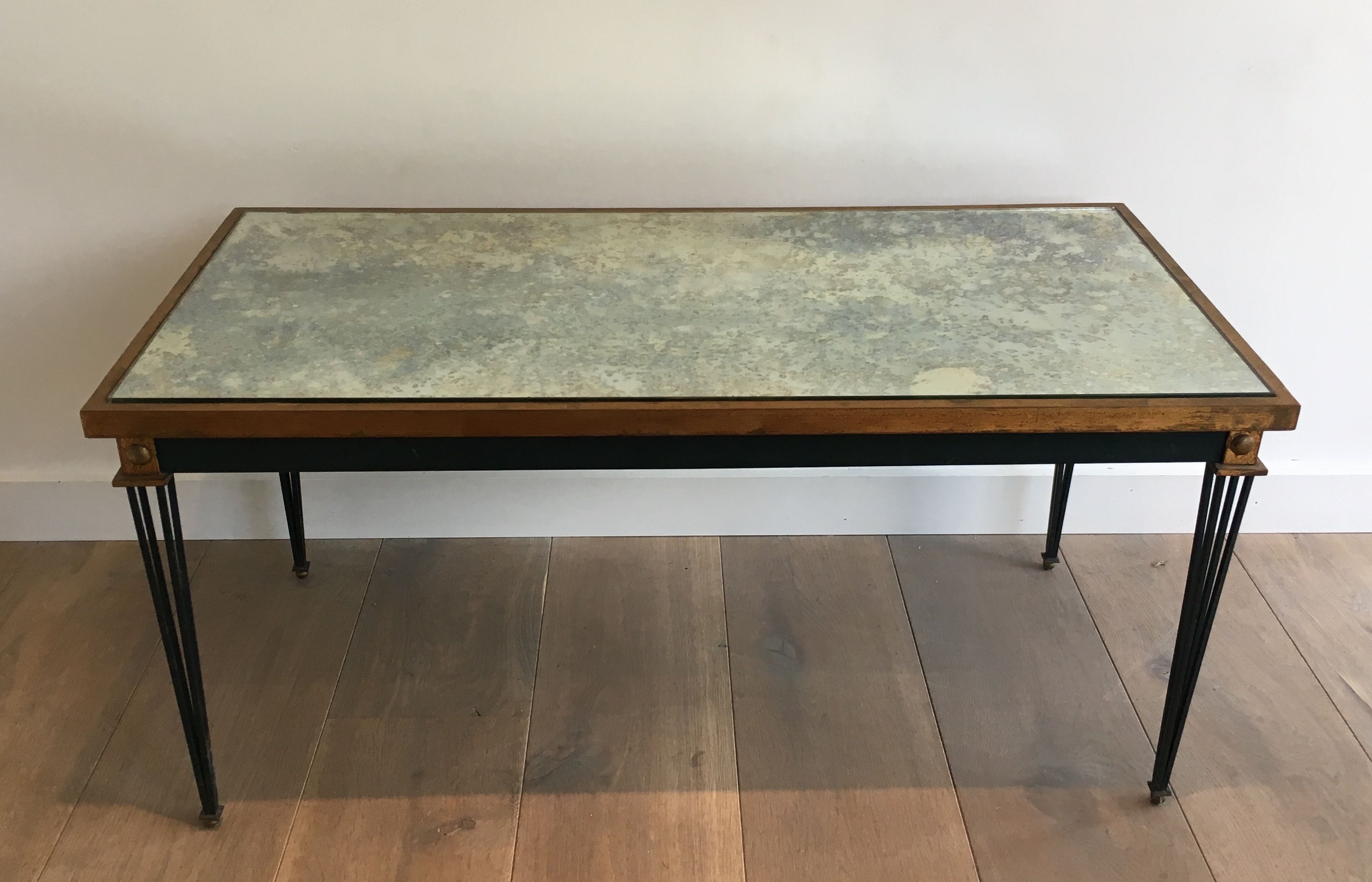 Patinated and gilded steel coffee table in the style of Jacques Quinet.