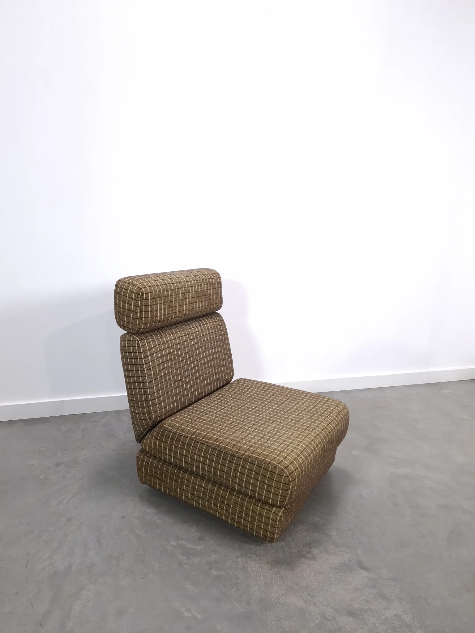 Vintage pull-out sofa bed, brown checked lounge chair with chrome.