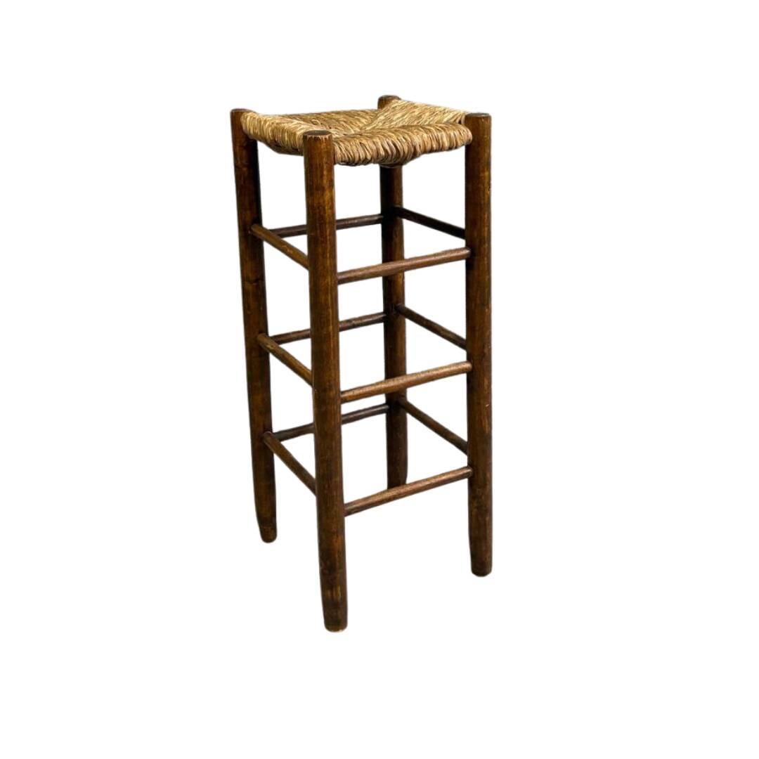 Vintage rustic style bar stool made of solid wood with a straw seat.