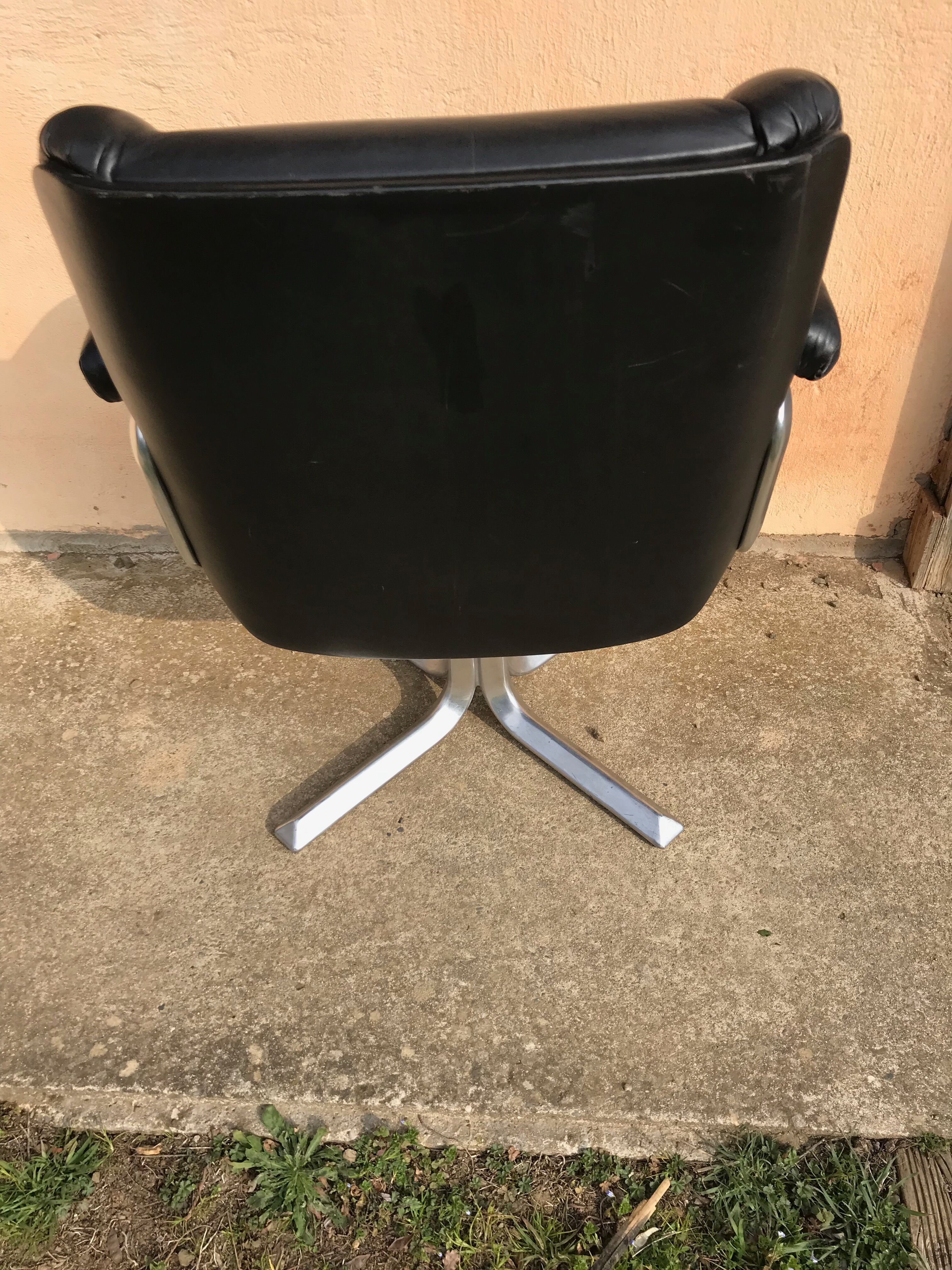 Vintage swivel black leather armchair