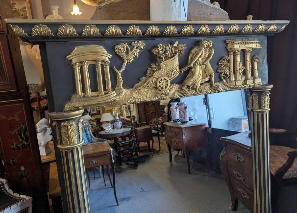 Large Empire-style mirror in dark green painted wood and gilded stucco.