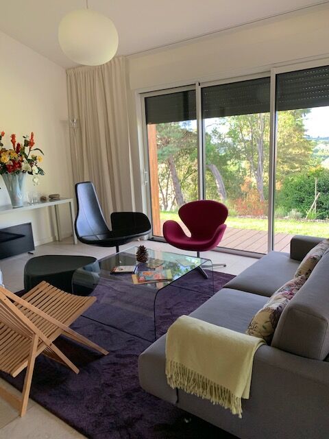 Moroso Fjord armchair with its pouf, design Patricia Urquiola 2002, steel and smooth black leather