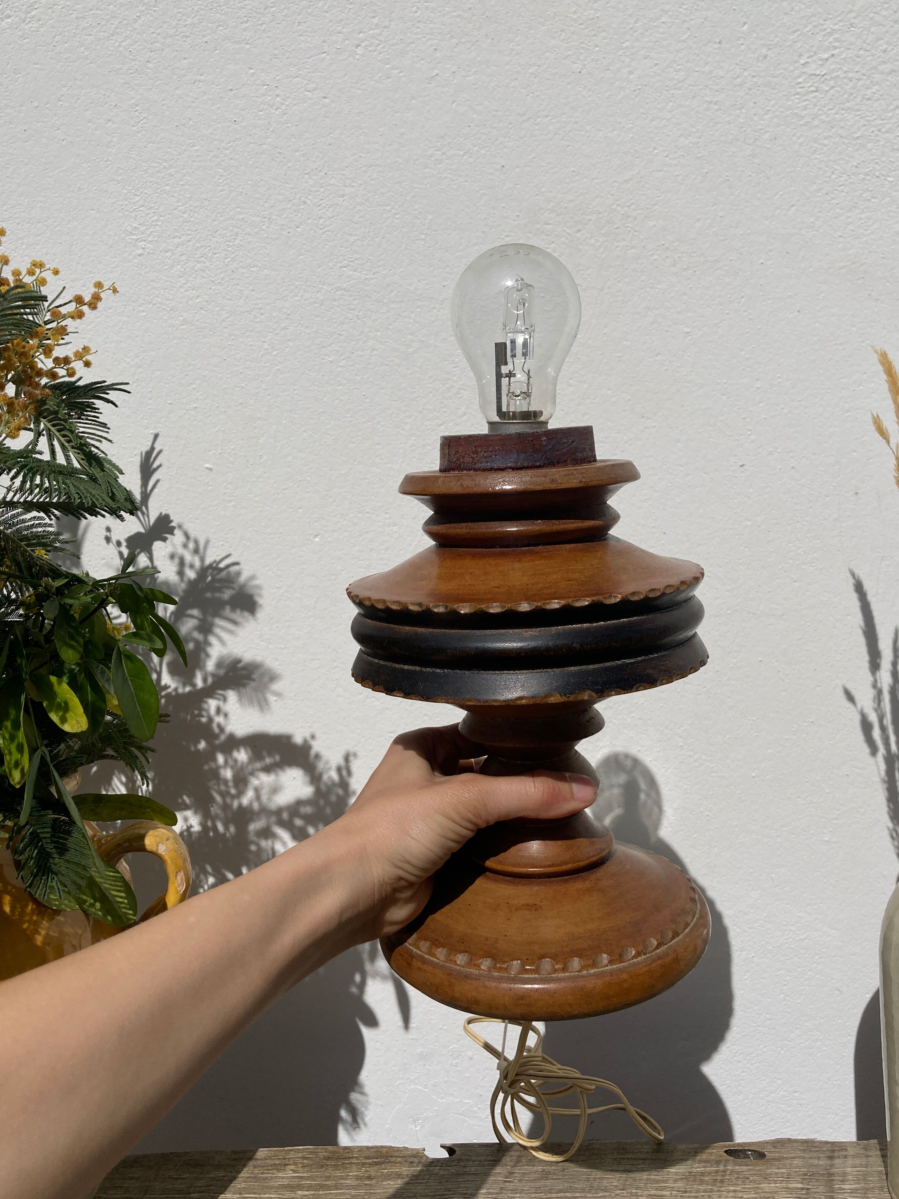 Foot of turned wooden lamp and carved