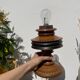 Foot of turned wooden lamp and carved