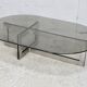 Coffee table with steel base and smoked glass slab. Circa 197