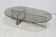 Coffee table with steel base and smoked glass slab. Circa 197