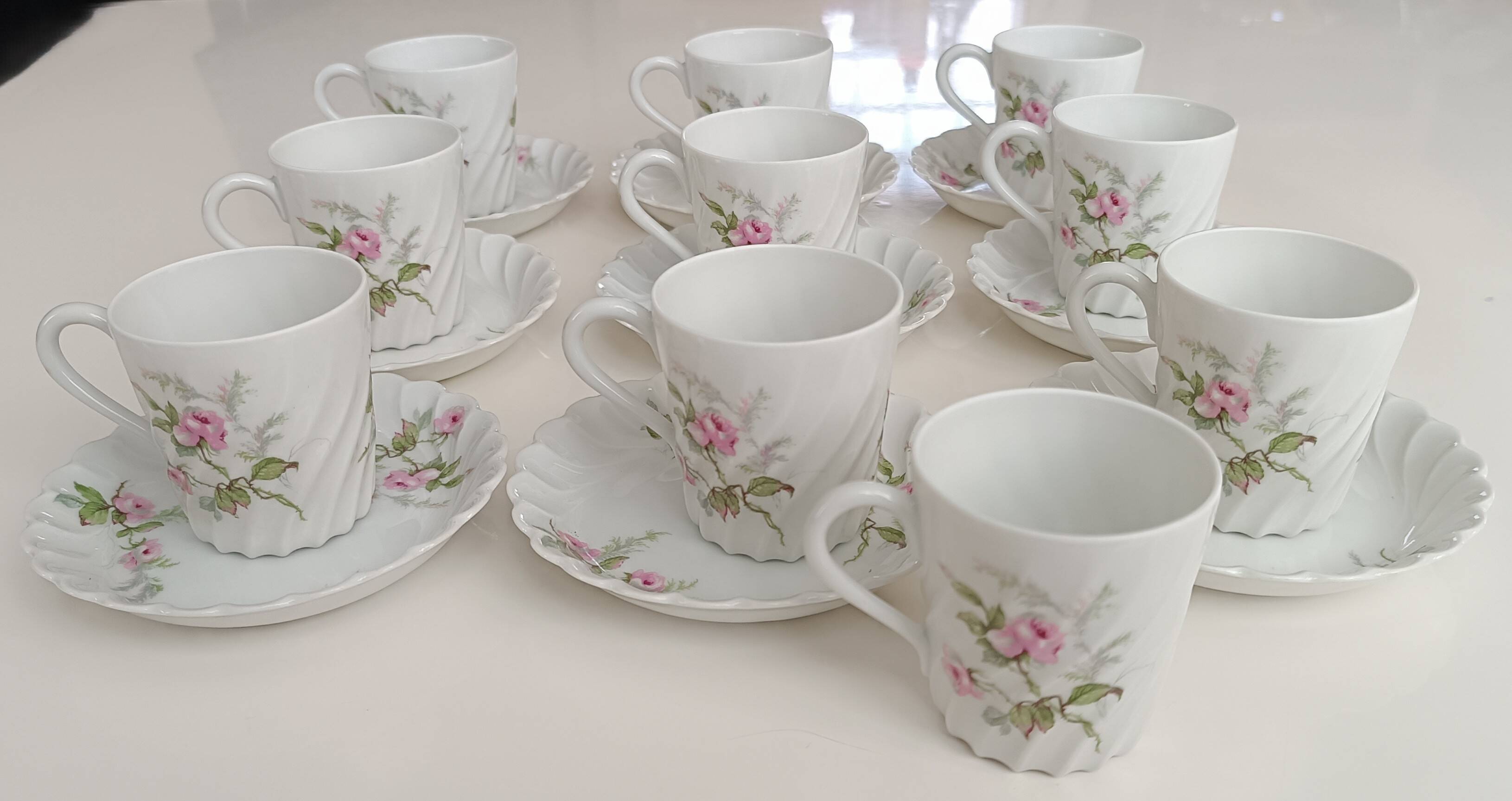 Haviland Limoges porcelain 10 coffee cups and 9 saucers with floral decoration.