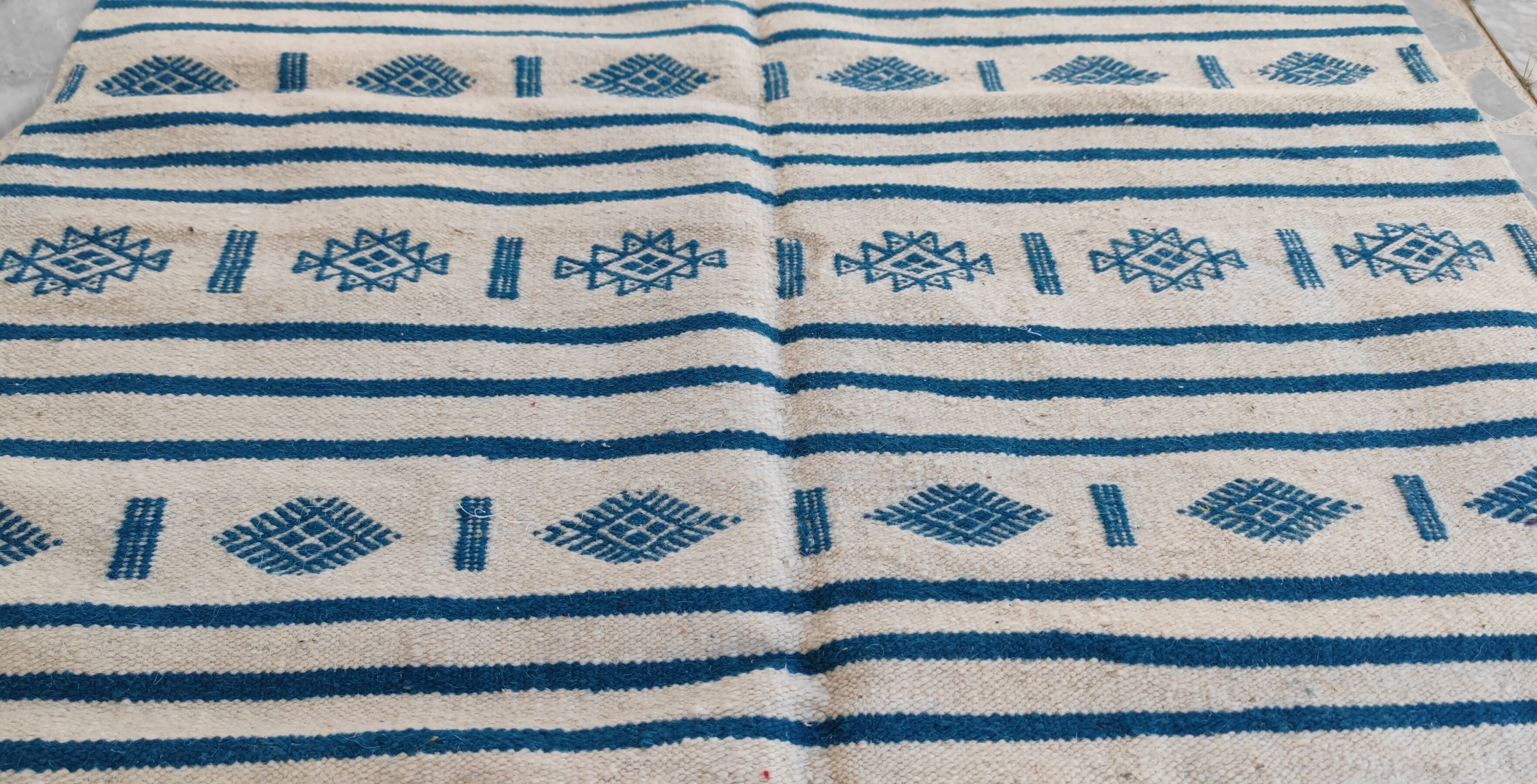 Traditional handmade white and blue kilim rug in natural wool