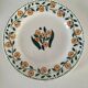 Set of 8 ironstone plates with coordinated designs.