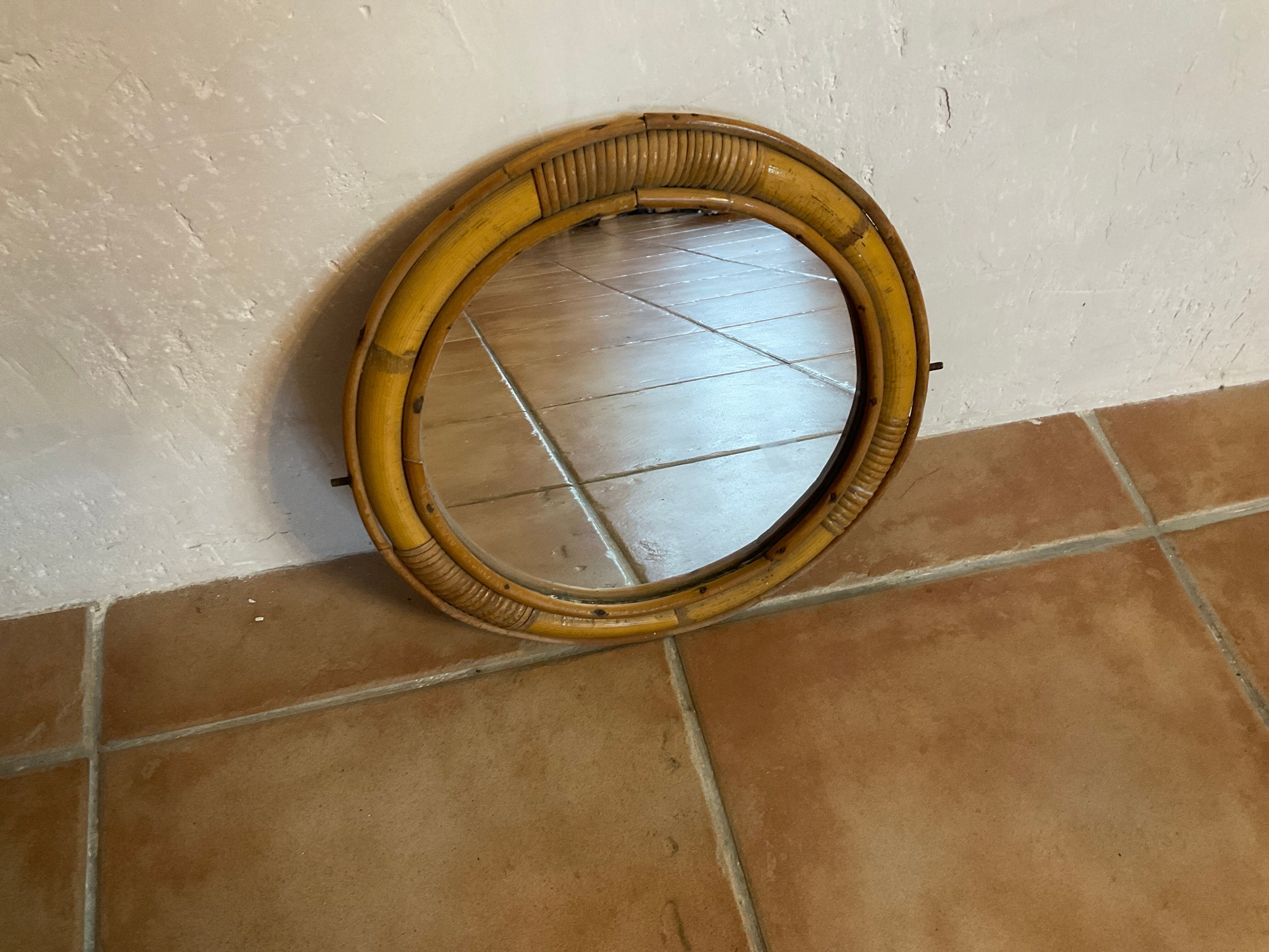 Old rattan mirror with porthole shape
