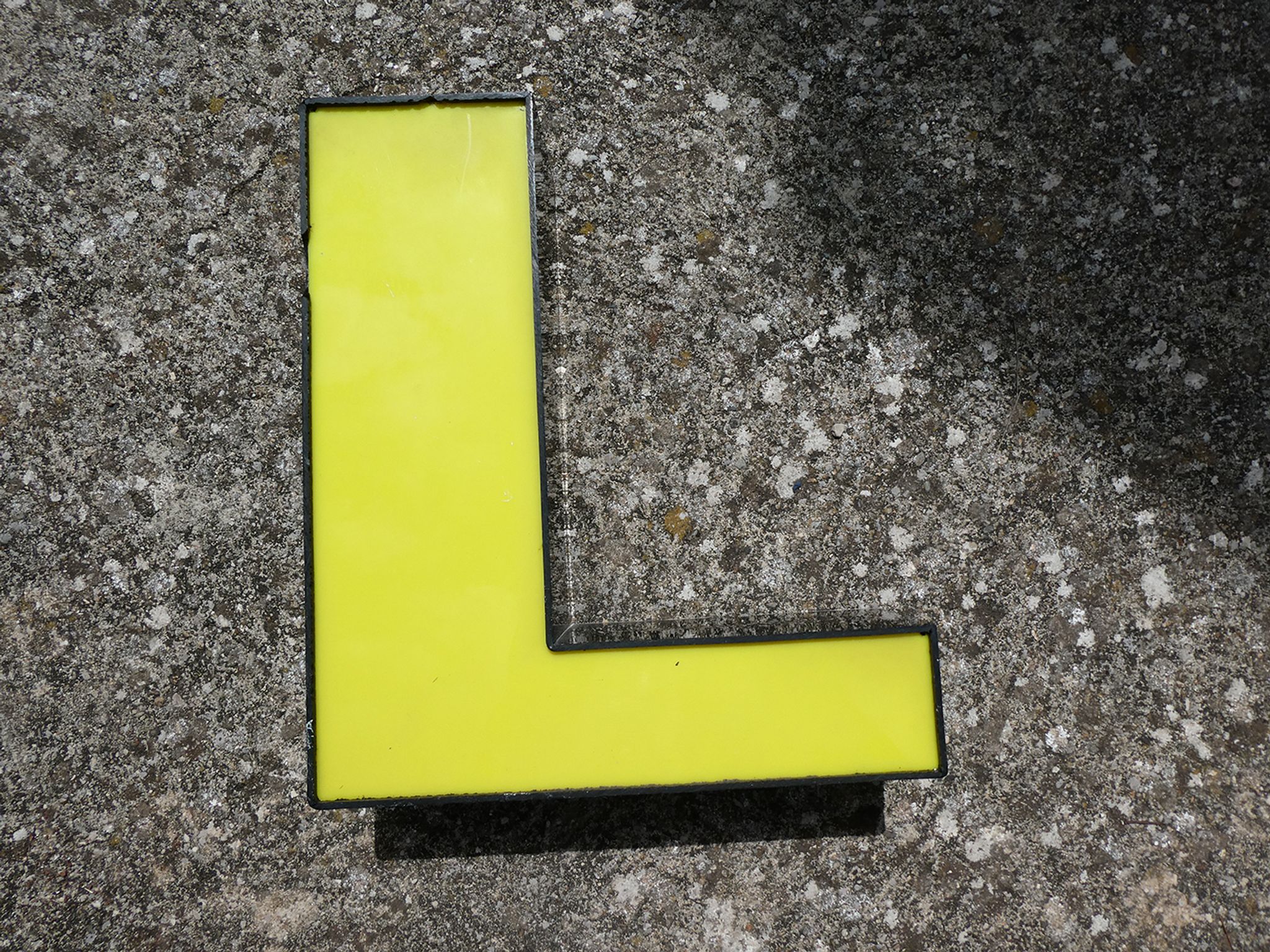 Letter "l" of industrial sign yellow and black