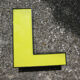 Letter "l" of industrial sign yellow and black