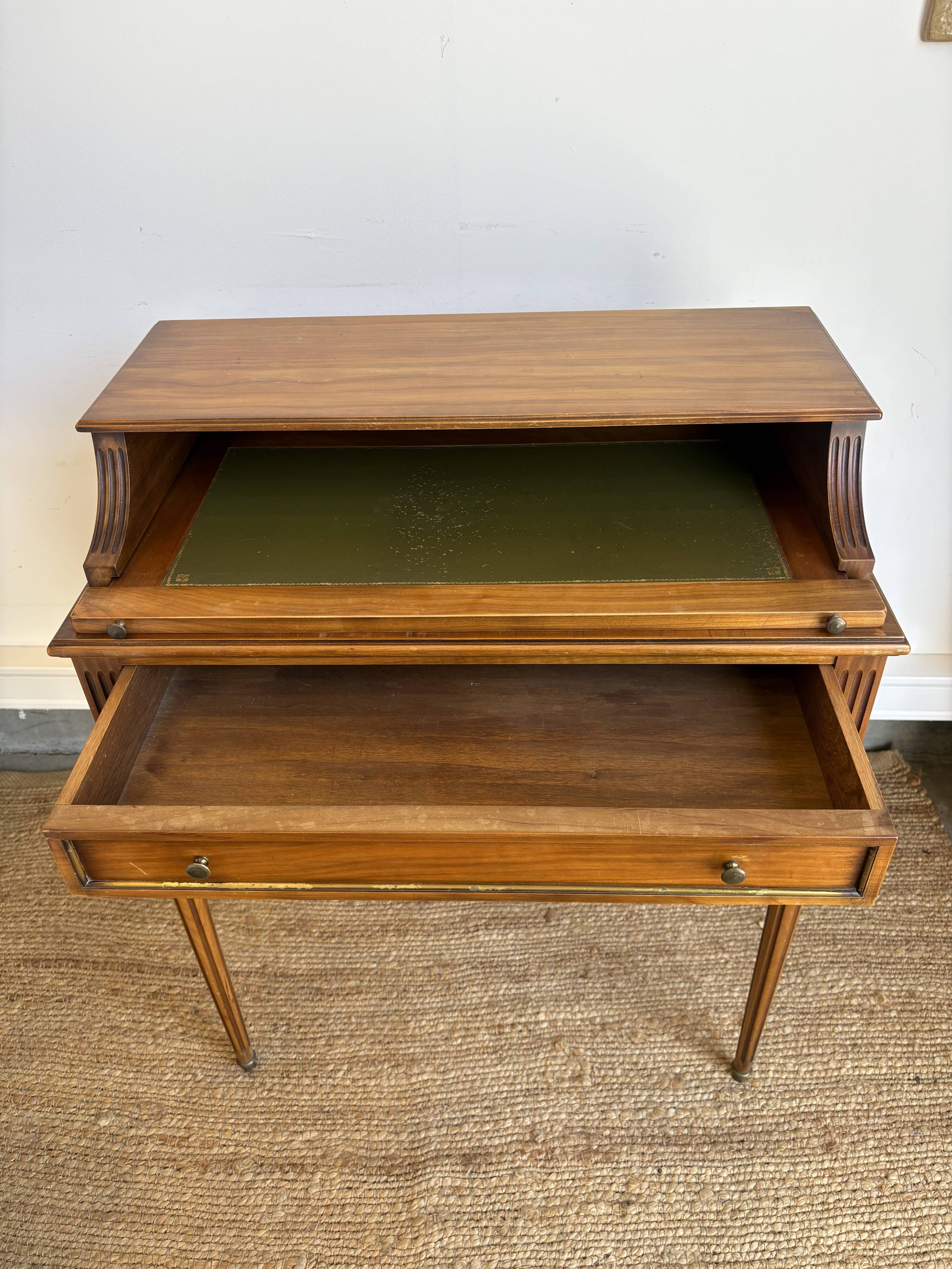 Louis XVI style mahogany telephone table with a green leather top.