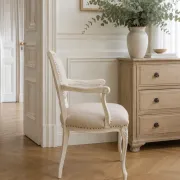 Louis XV style armchair, delicately patinated in a soft beige hue.