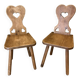 Pair of vintage wooden chairs in alpine chalet style.