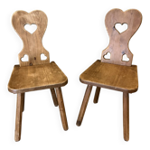 Pair of vintage wooden chairs in alpine chalet style.