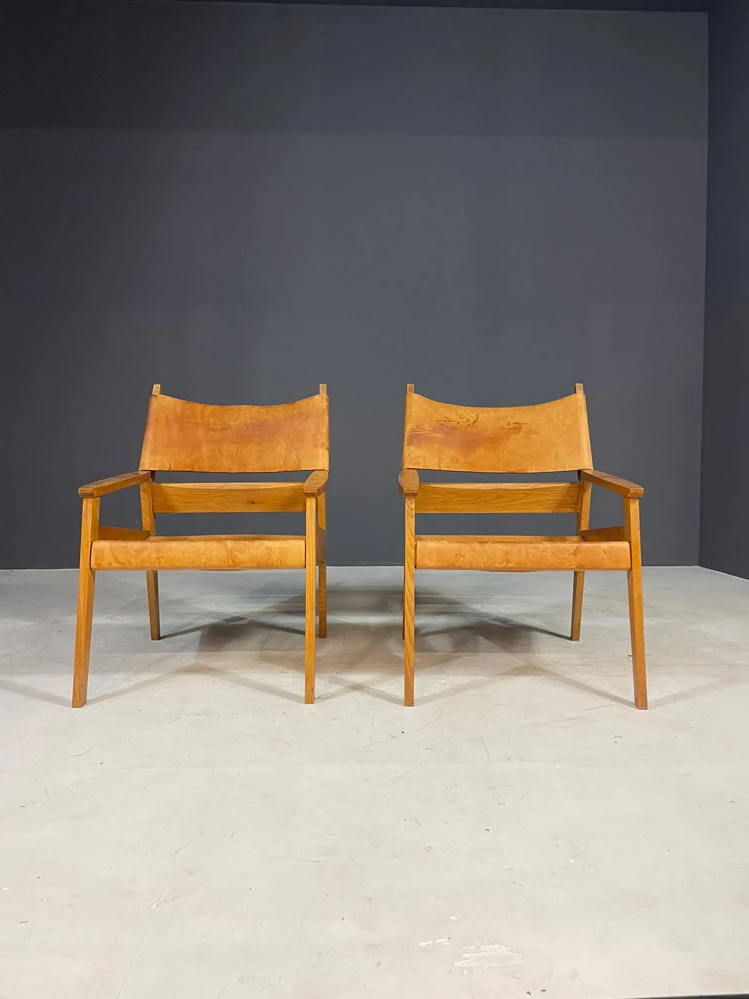 Pair of vintage wooden armchairs with leather upholstery, 20th century, 75 × 56 × 65 cm
