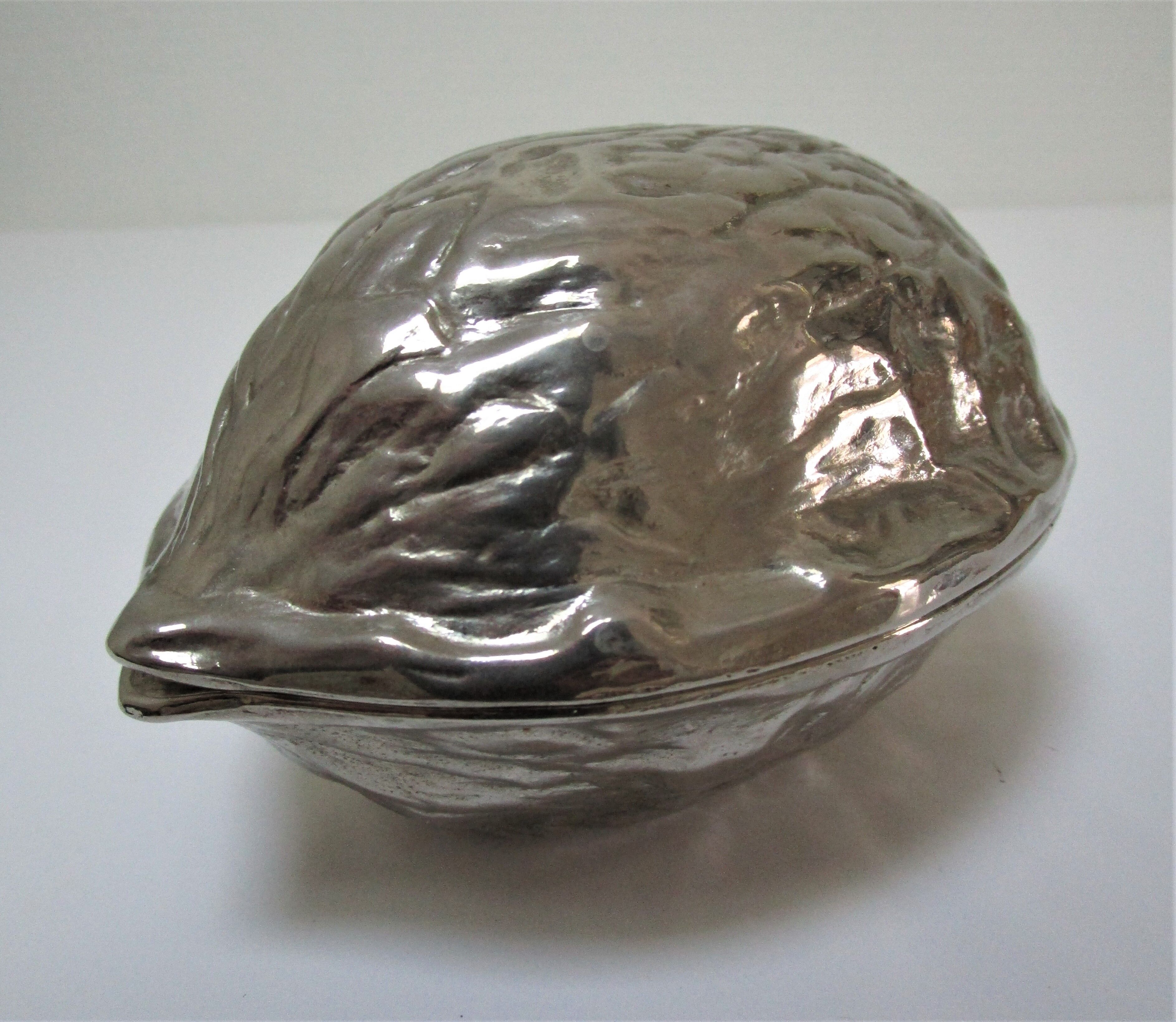 silver metal nutcracker in the shape of vintage walnuts