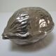 silver metal nutcracker in the shape of vintage walnuts