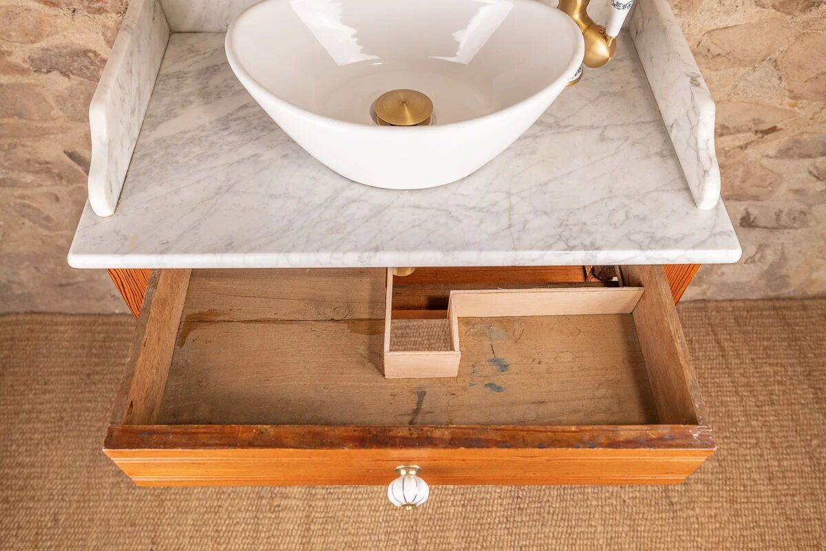 Antique washbasin cabinet in solid pitch pine with a white marble top.