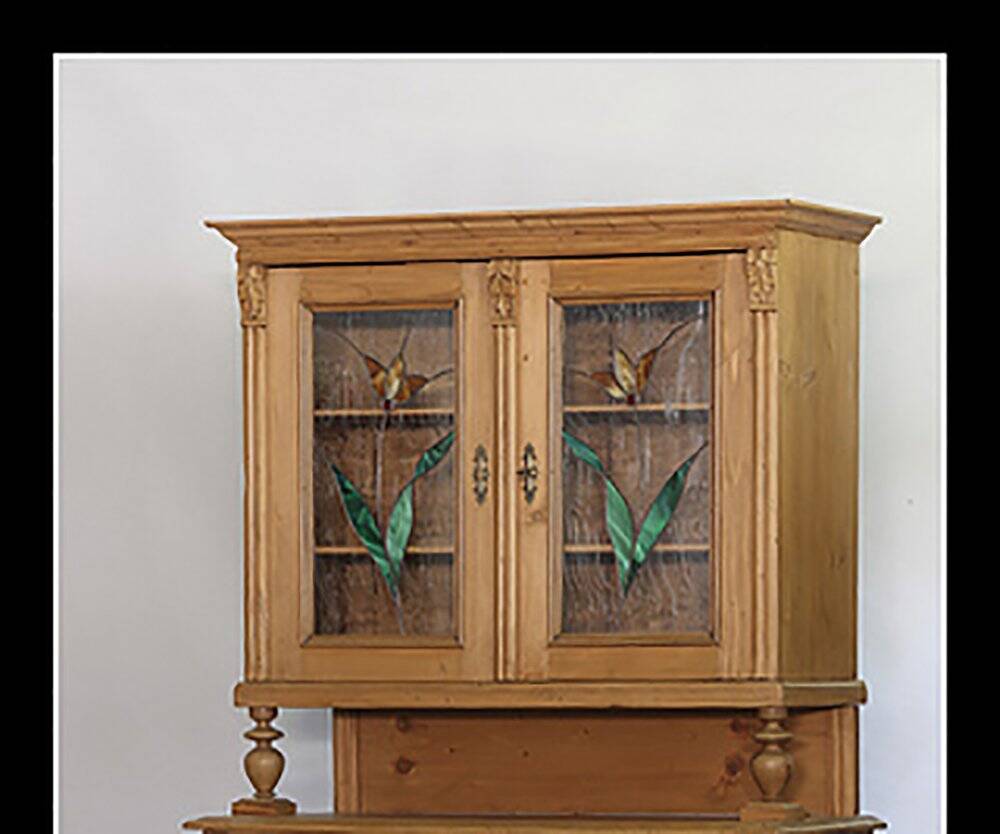 Brown pine kitchen cabinet with floral stained glass, 1920s vintage style.