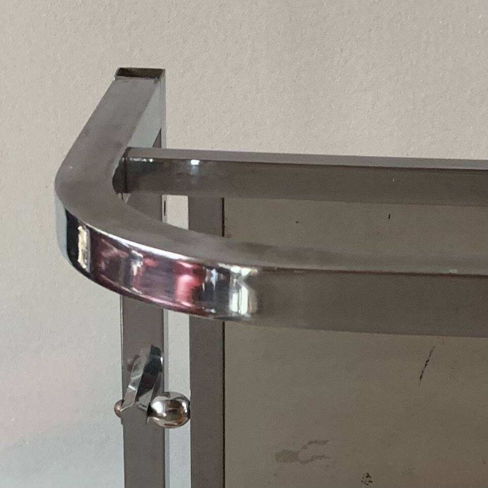 Vintage wall-mounted coat rack in chrome metal with integrated mirror and hat rack