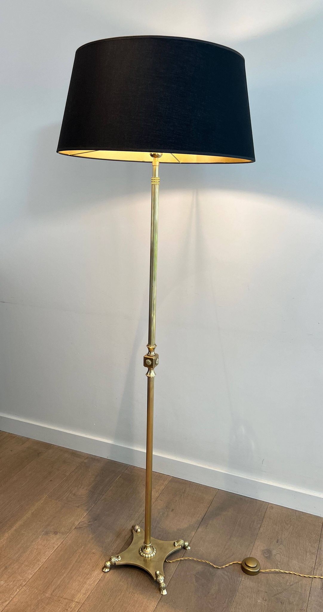 Neoclassical brass floor lamp with claw feet from Maison Jansen.