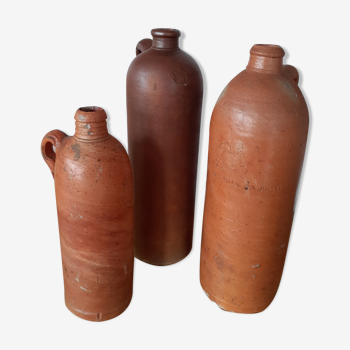 Set of three old sandstone bottles