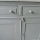 Antique sideboard enhanced in verdigris, wooden top.
