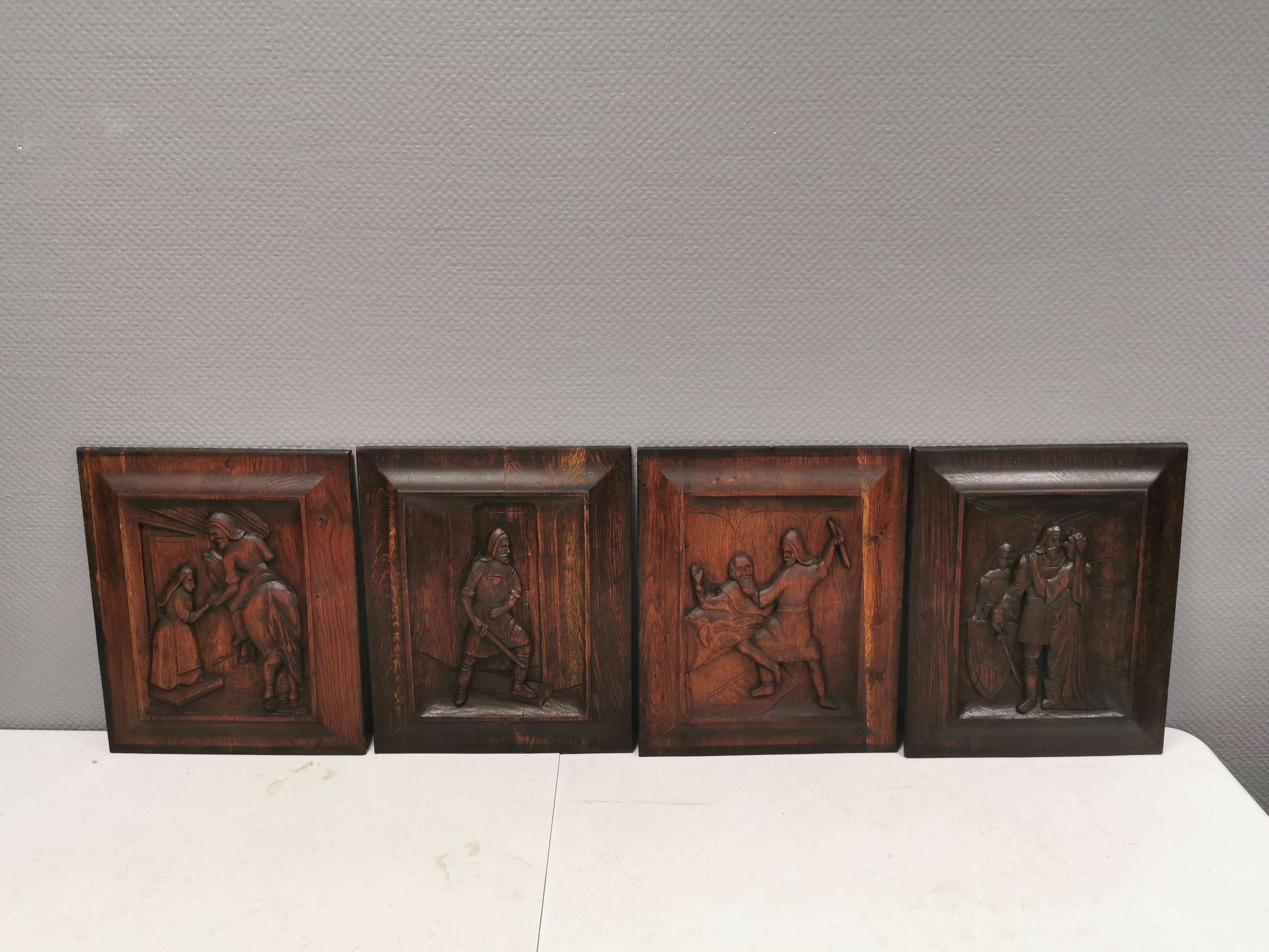 Four old wooden carvings to hang on the wall.
