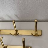 Three vintage 1960s gold coat racks 4, 3 and 2 hooks