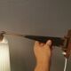 Wall lamp with adjustable ‘arm’ in copper and rosewood, with white shade.