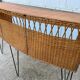 Vintage 1950s bar counter with its two rattan and metal stools.