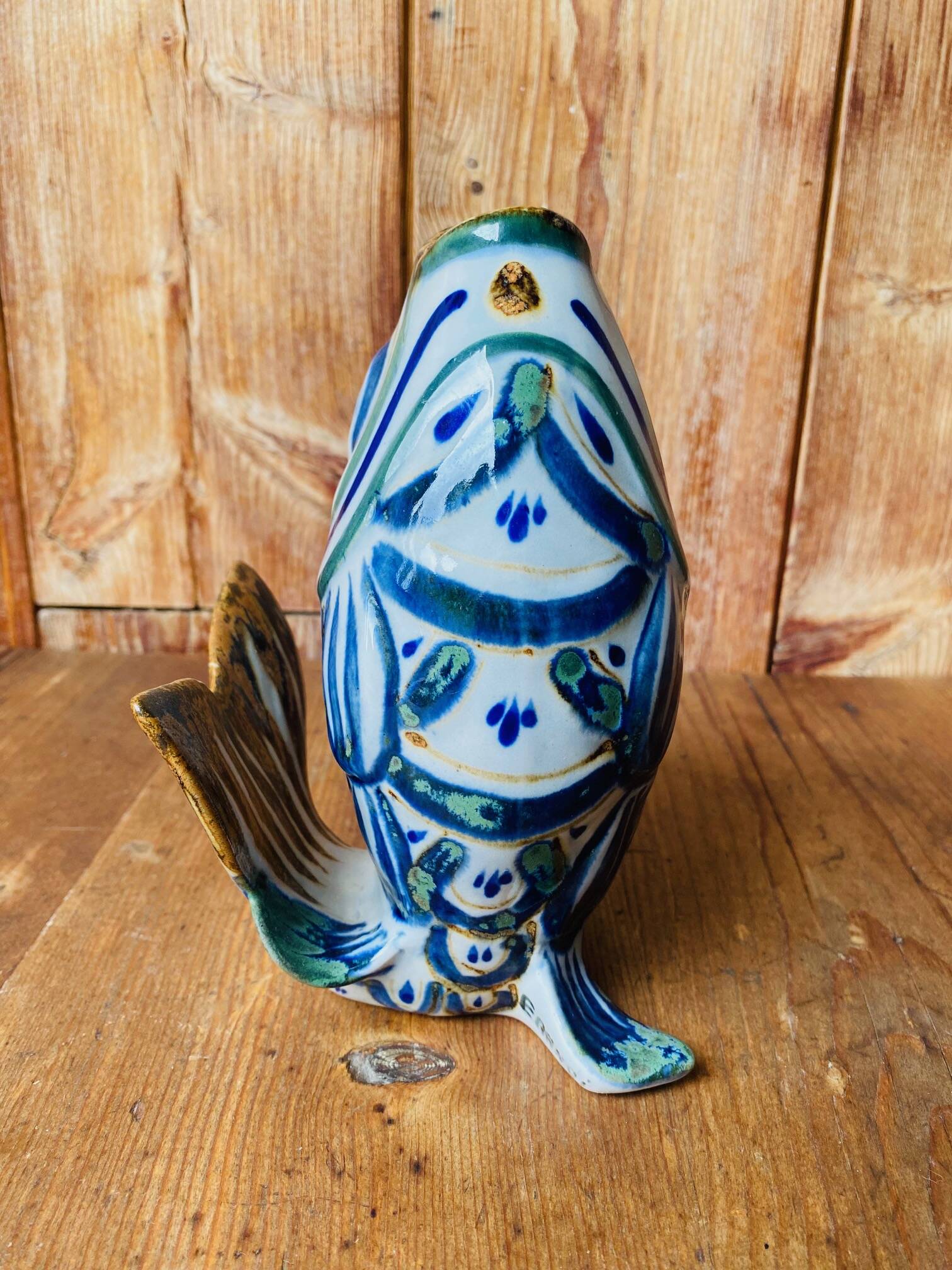 Blue ceramic zoomorphic vase in the shape of a poison.