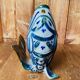 Blue ceramic zoomorphic vase in the shape of a poison.