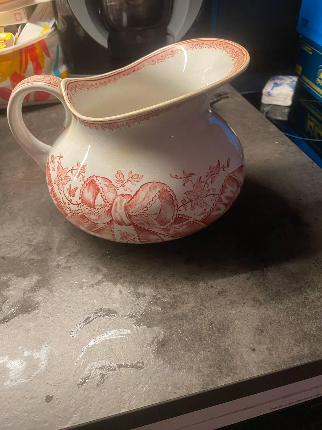 Old pitcher in red-decorated earthenware.