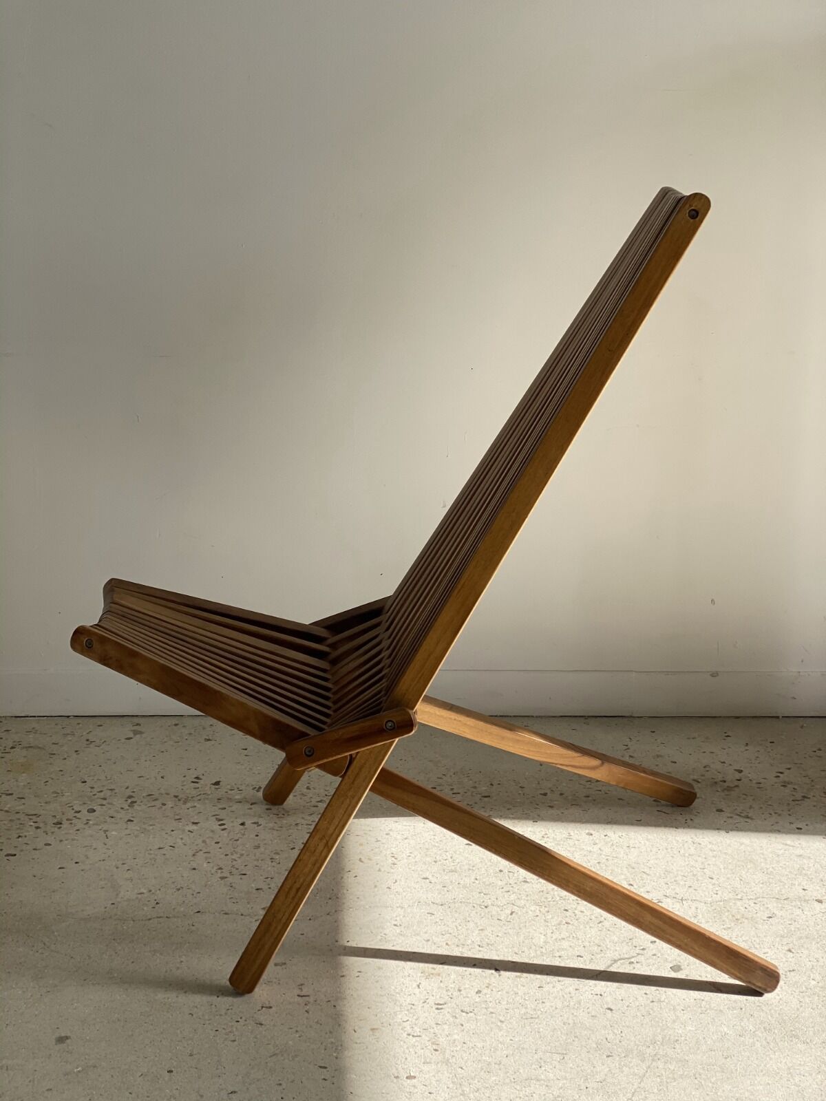 Foldable designer armchair in wooden slats